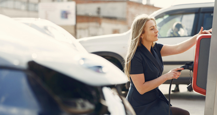 woman at ev charging station