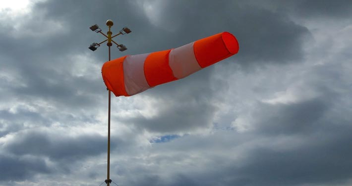 wind sock blows with dark clouds in background