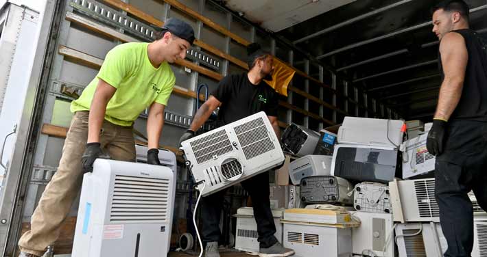 Air conditioners and dehumidifiers are loaded on a truck