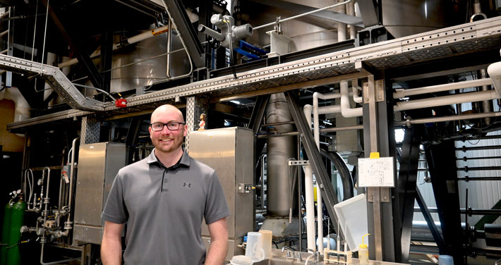 Trevor Bland stands by heat exchange of the brewhouse