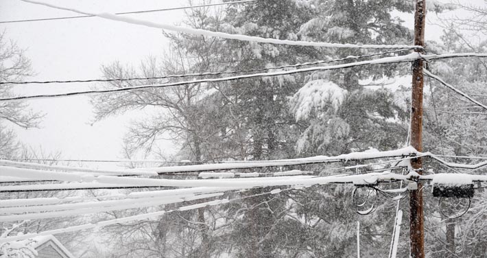 close up view of snow build up on power lines